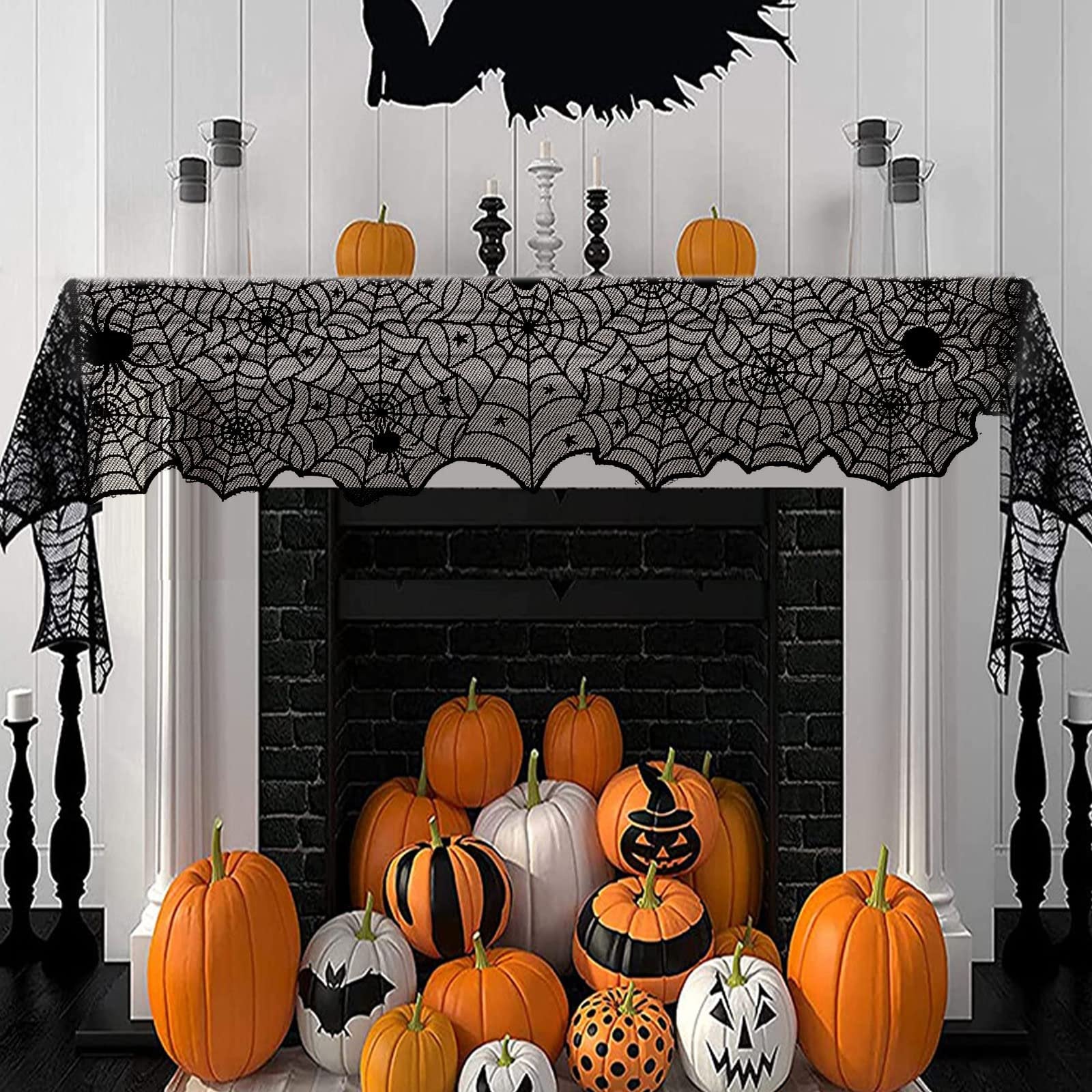 Halloween black lace spider web table runner draped over a fireplace mantel with pumpkins and decorations
