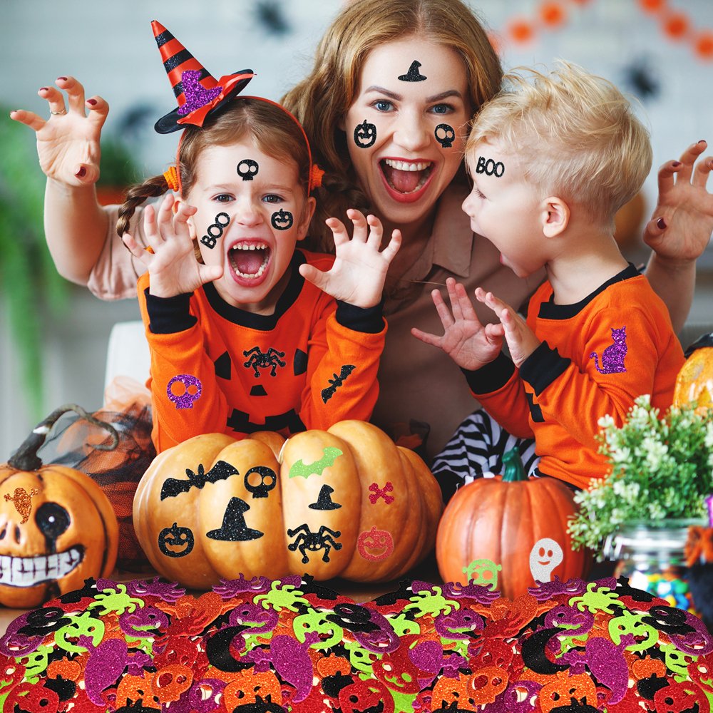 Mother and two children wearing Halloween costumes and face stickers, surrounded by pumpkins and glitter foam stickers.