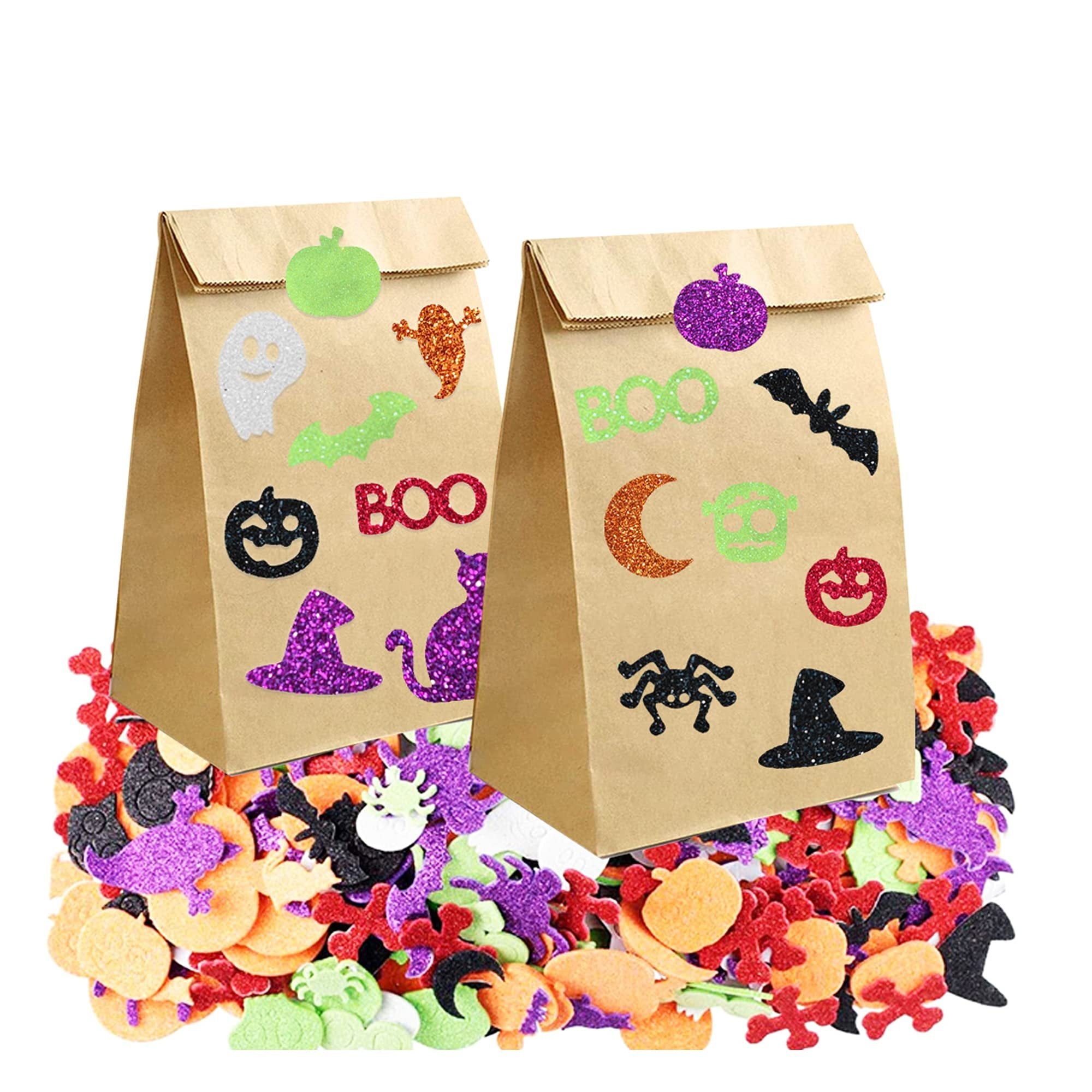 Two brown paper bags decorated with Halloween glitter foam stickers, surrounded by a pile of assorted foam stickers.