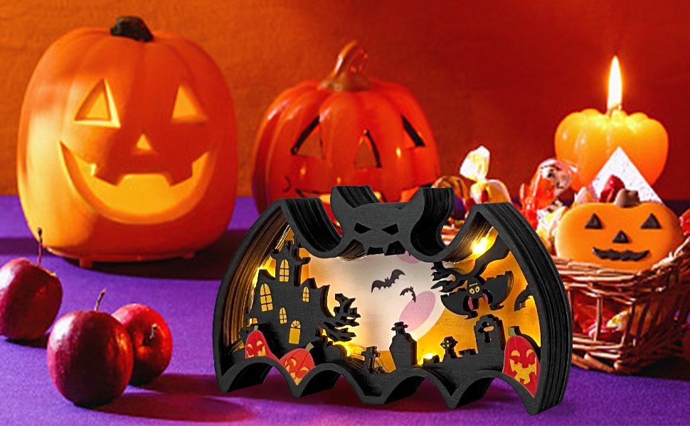 Halloween light-up bat shadow box with spooky scene, surrounded by pumpkins and candy.