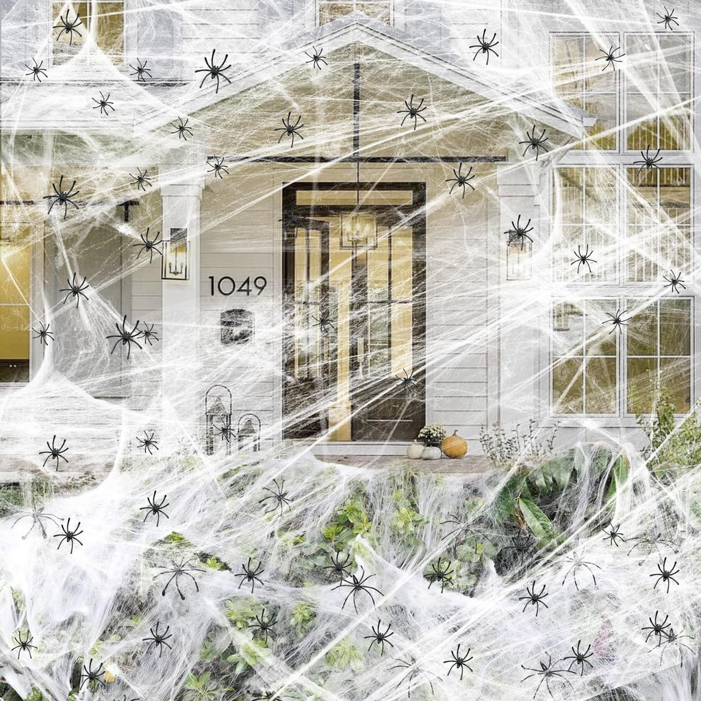 Halloween cobweb decoration with fake spiders covering a house exterior and porch