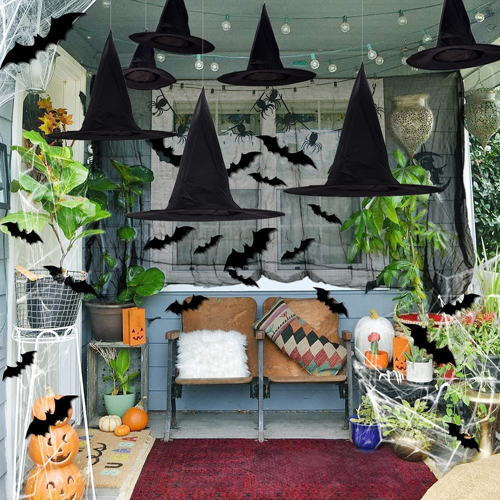 Halloween porch decorated with black witch hats, bats, spiders, and pumpkins.