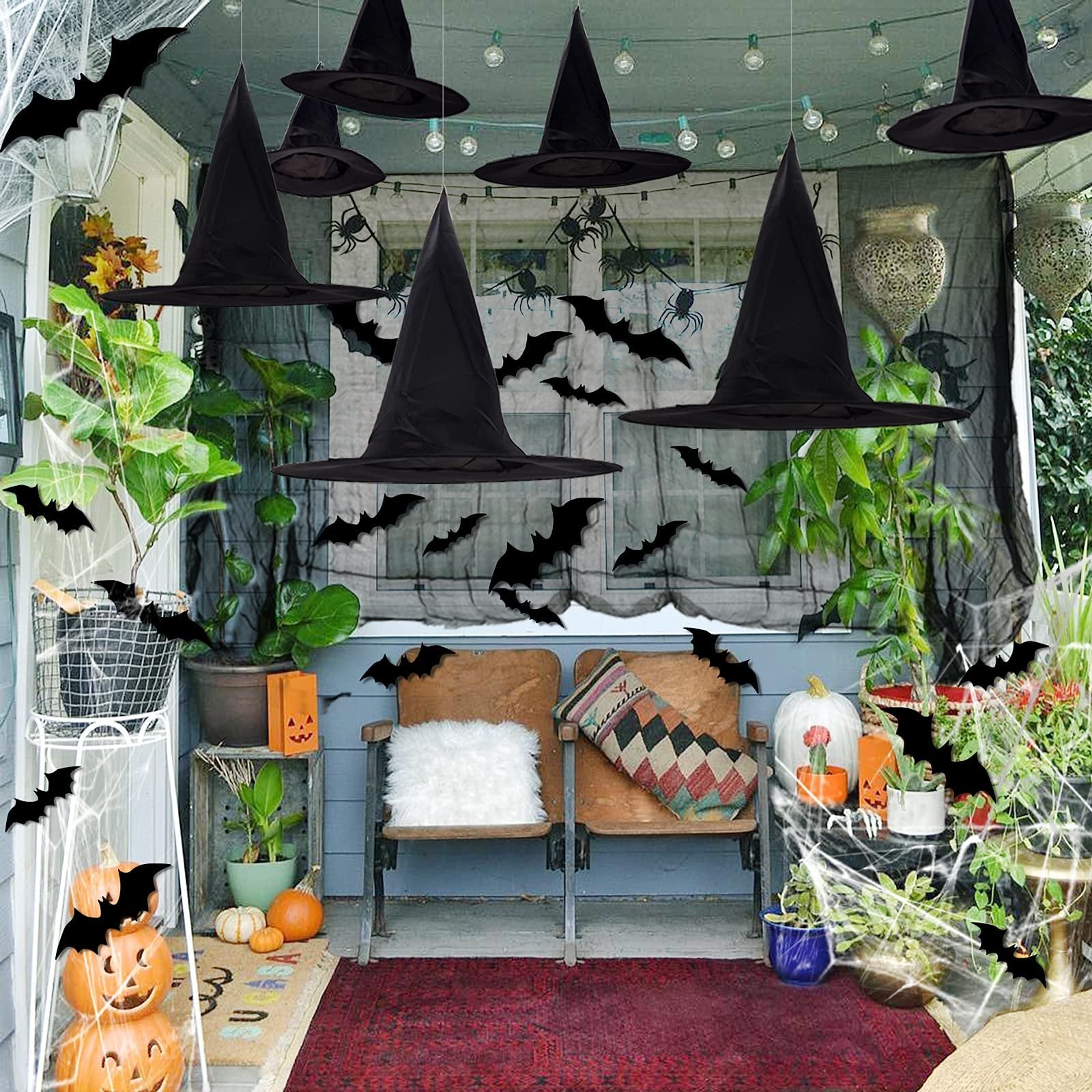 Halloween porch decorated with black witch hats, bats, spiders, and pumpkins.