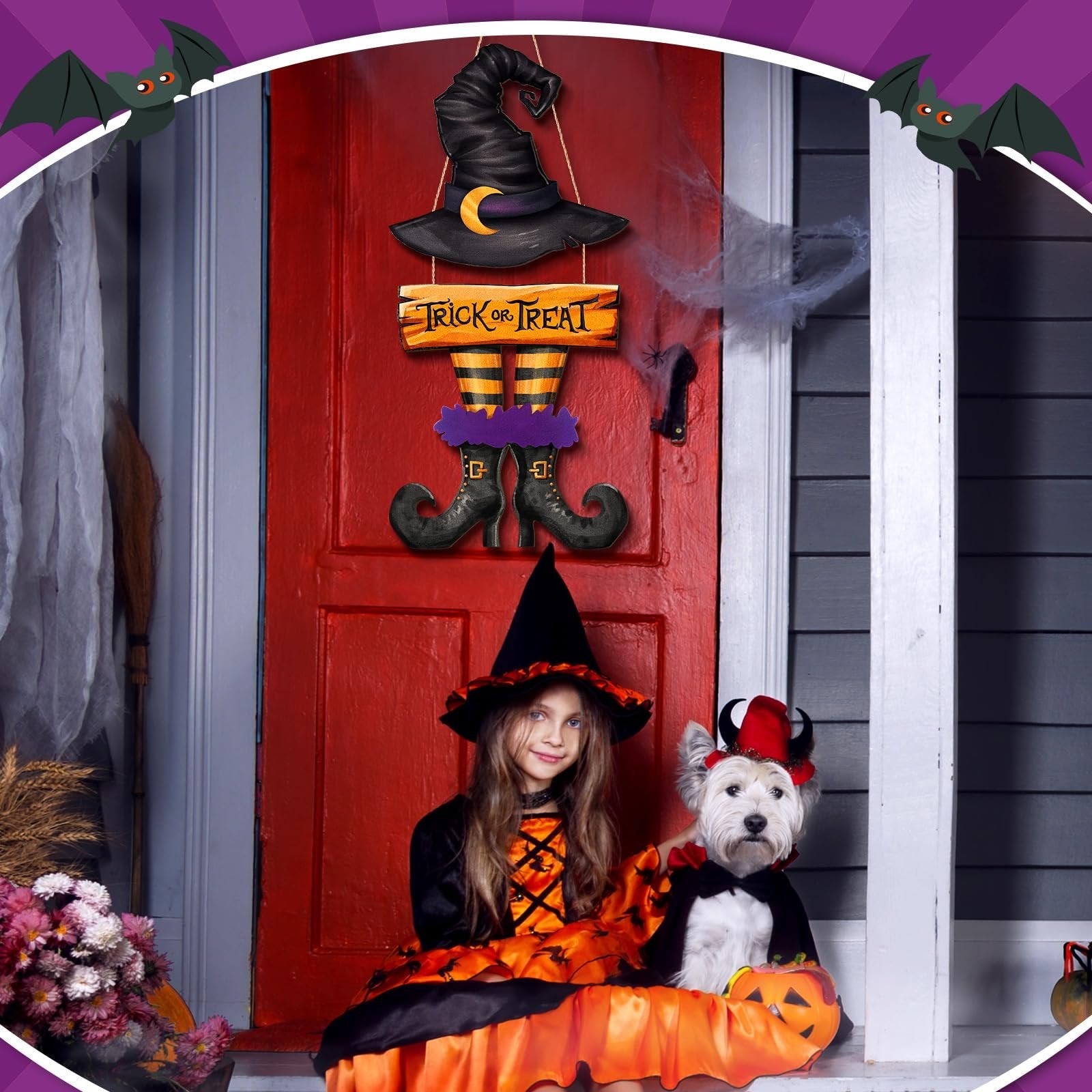 Halloween witch hat and legs door sign hanging on a red door with a girl and dog in costumes on the porch