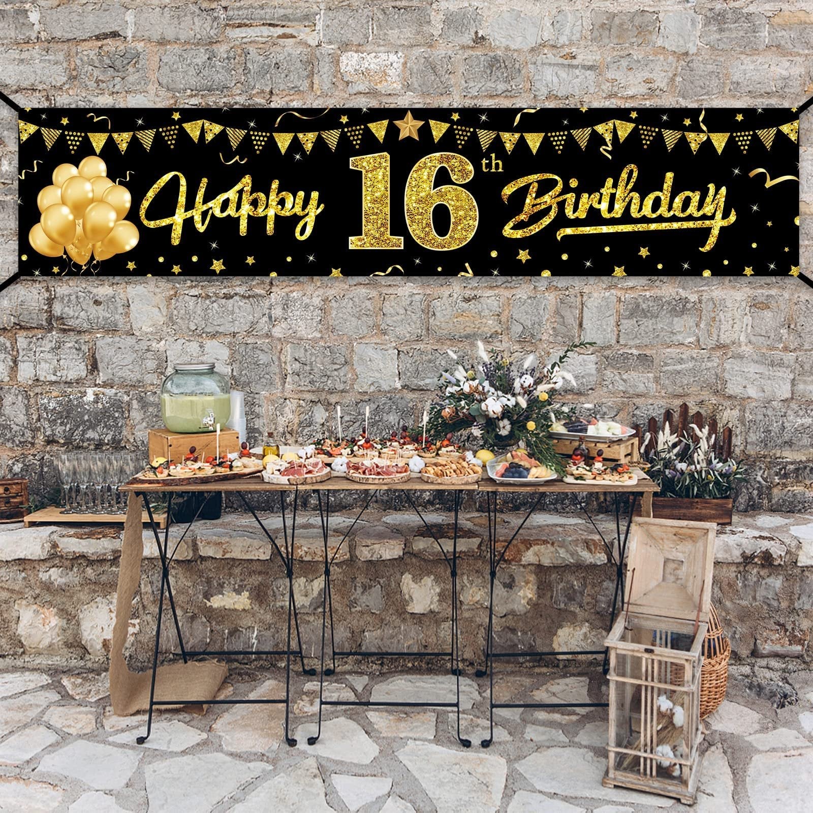 Black and gold 'Happy 16th Birthday' banner with balloons and bunting, displayed above a party food table.