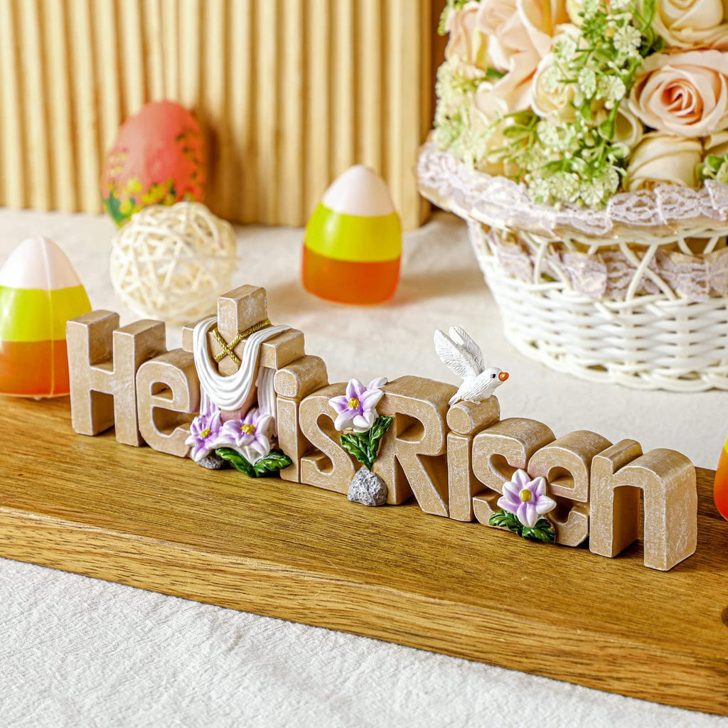 Easter tabletop sign with letters spelling 'He is Risen', featuring a cross, dove, and flowers.
