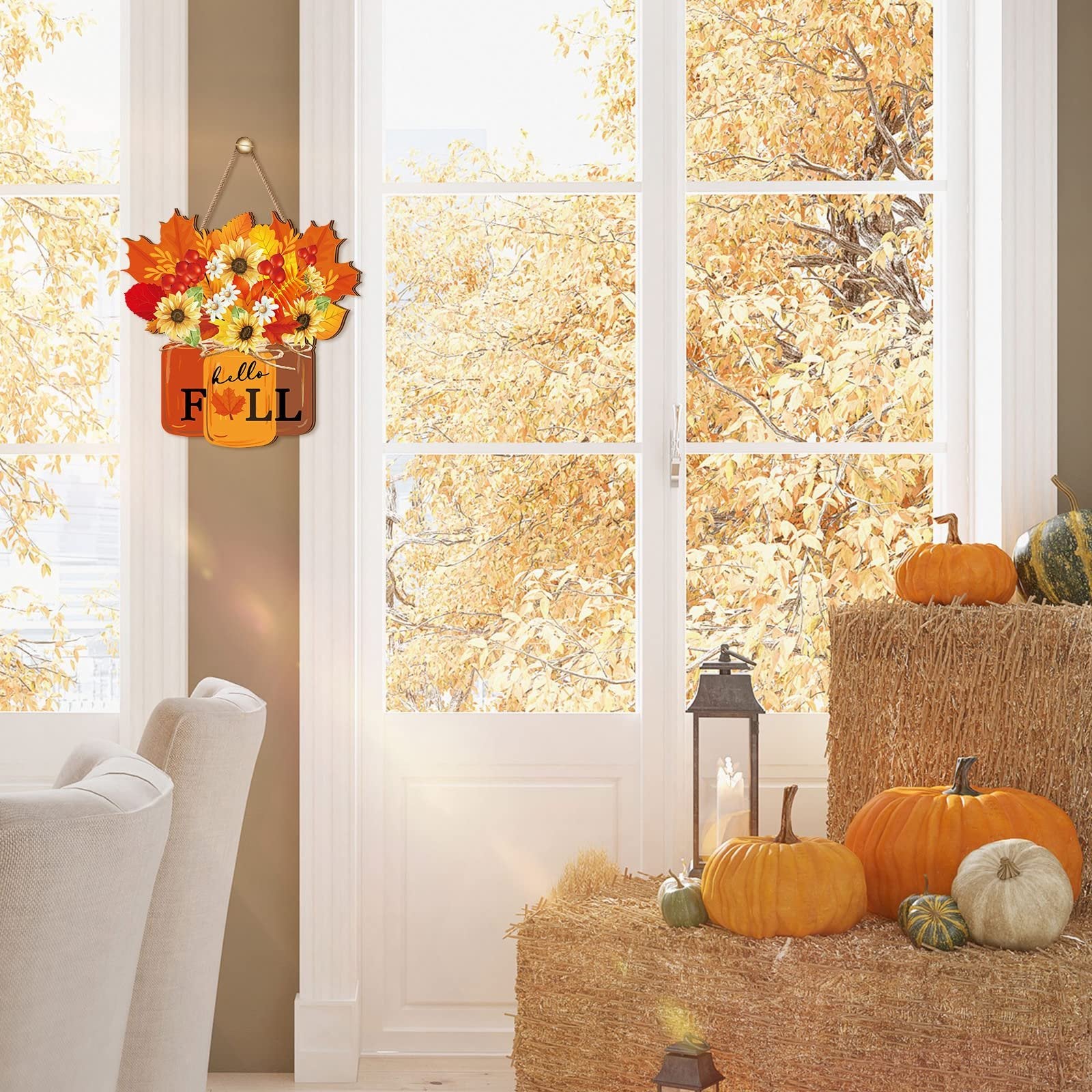 Autumn door sign with sunflowers and maple leaves hanging on a door with pumpkins and hay bales nearby