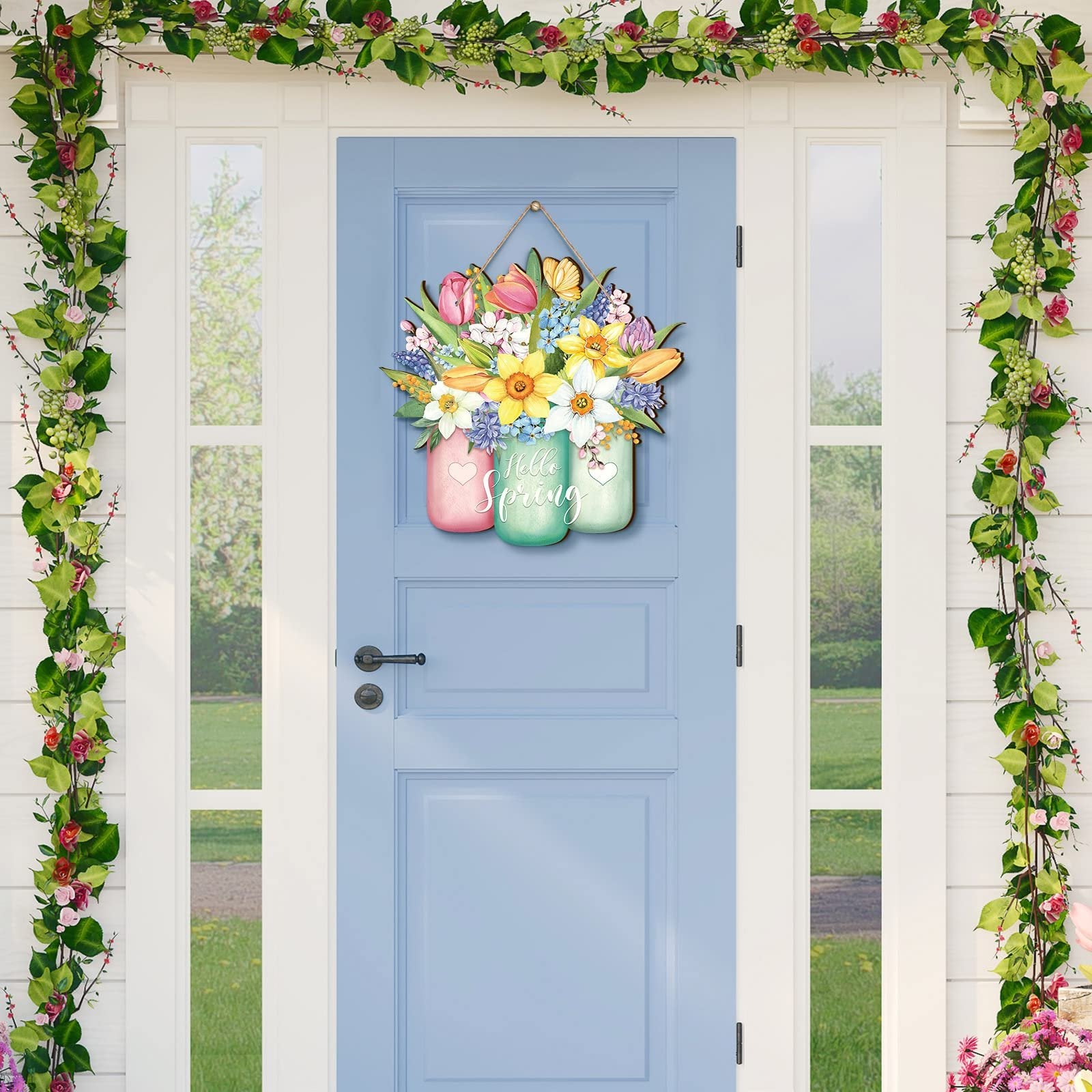 Wooden door sign with colorful spring flowers in mason jars, reads 'Hello Spring'
