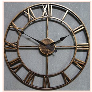 Large metal wall clock with Roman numerals and black spade hands against a gray background