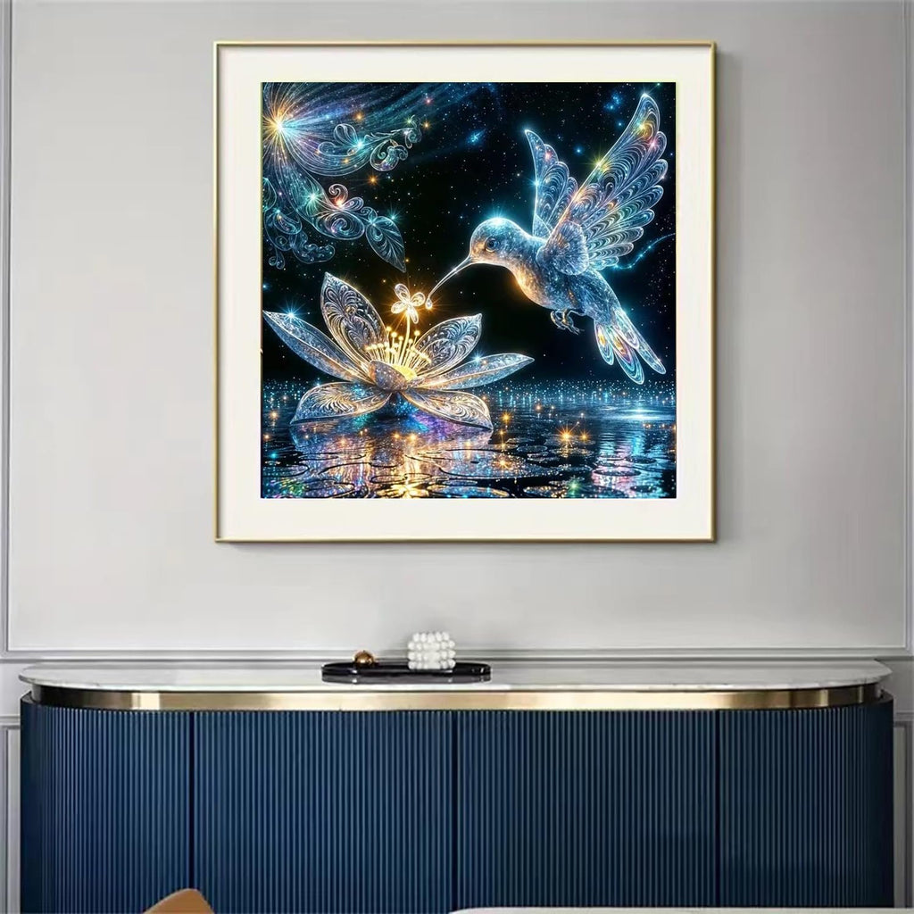 Diamond painting kit featuring a luminous hummingbird hovering over a glowing lotus flower with reflections on water.