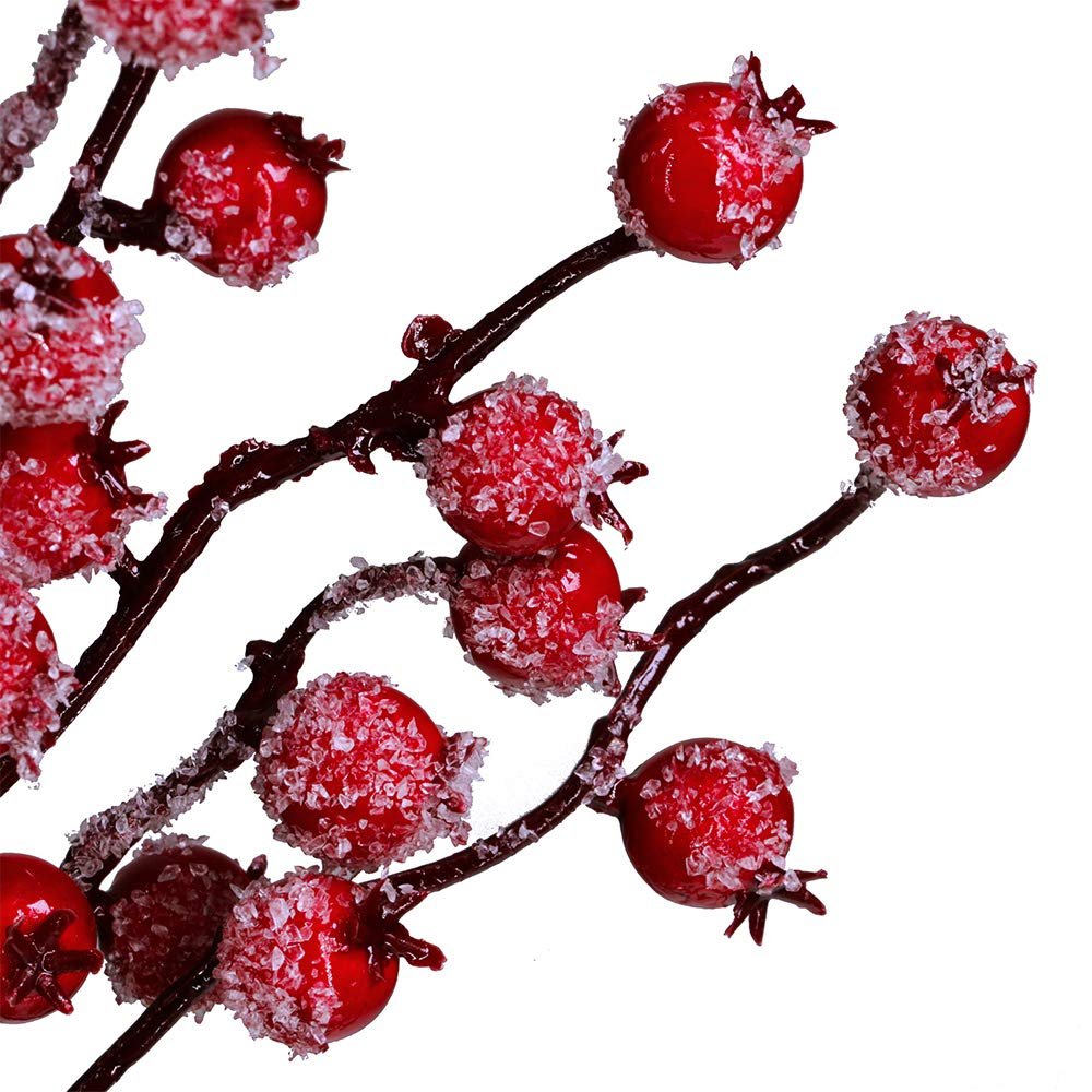Artificial red berry picks with frosted stems and berries, close-up on white background
