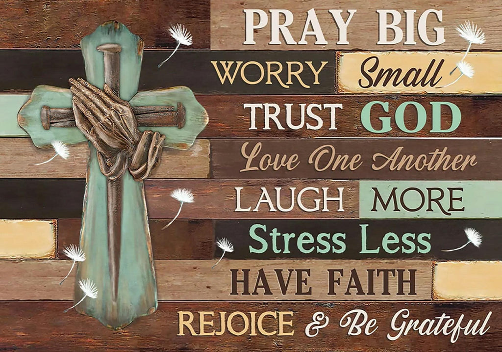 Religious cross with praying hands and inspirational quotes on a wooden plank background.