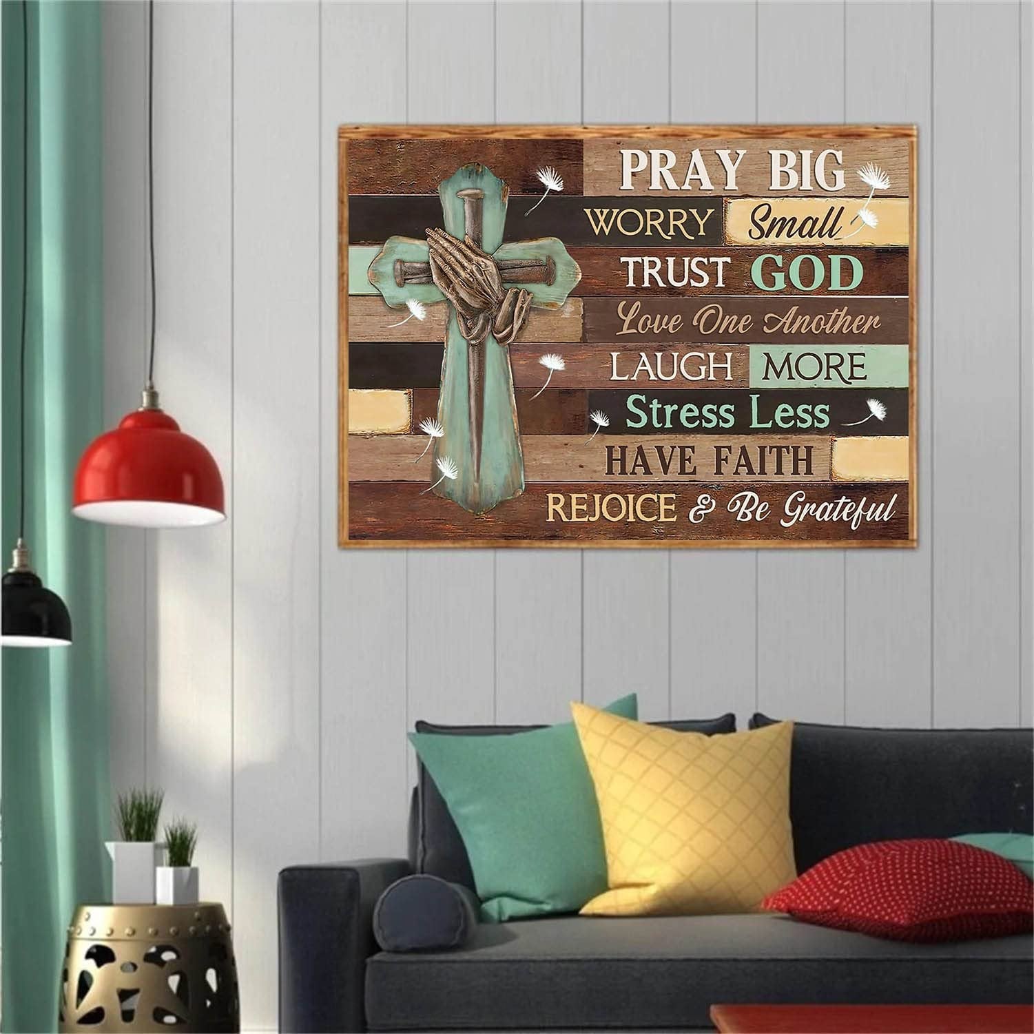 Jesus cross with praying hands and inspirational quotes on a wooden plank background, displayed in a living room setting.