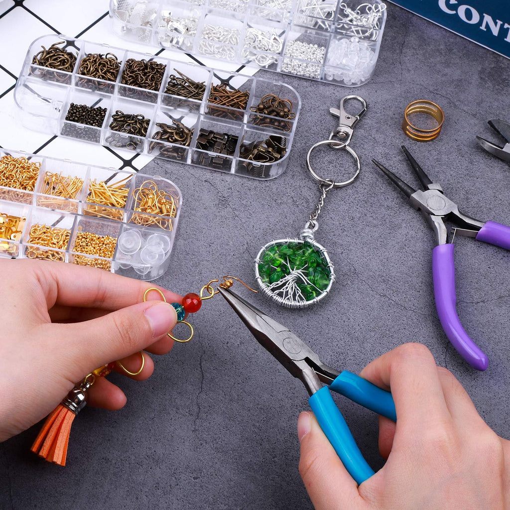 Hands using pliers to craft jewelry with assorted findings and tools laid out on a dark surface.