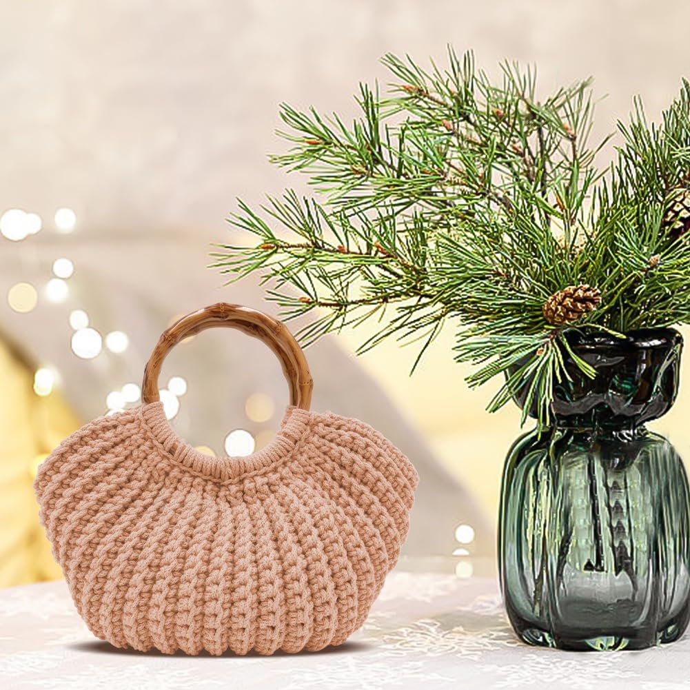 Khaki crochet tote bag with wooden handles, displayed next to a vase of pine branches.