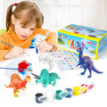 Young girl painting dinosaur figurines with a kit including paint pots, brushes, and white dinosaur models.
