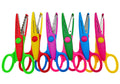 Set of six decorative scissors with different wavy cutting blades and colorful handles on a white background.
