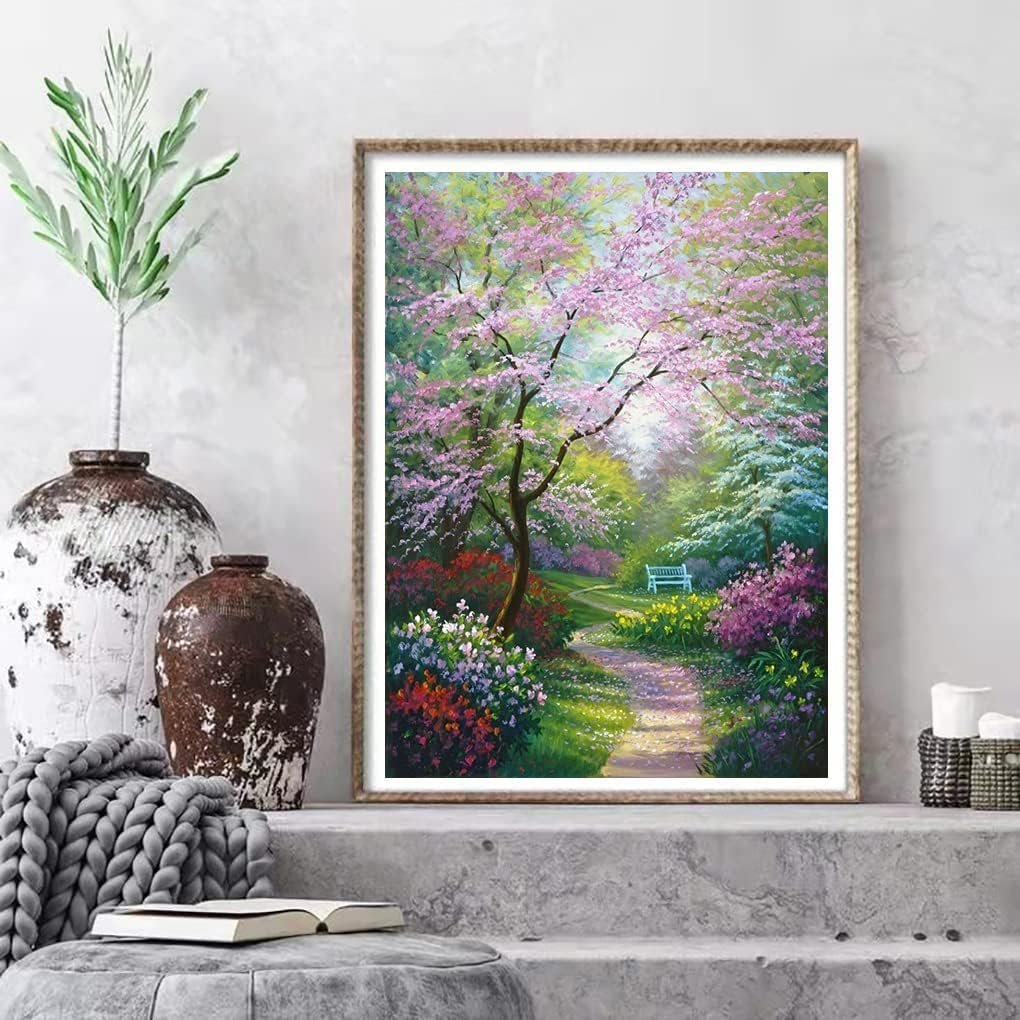 Diamond painting kit depicting a serene garden path lined with blooming trees and colorful flowers, leading to a white bench.