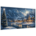 Winter village scene with a decorated Christmas tree by a lake and snow-covered mountains in the background.