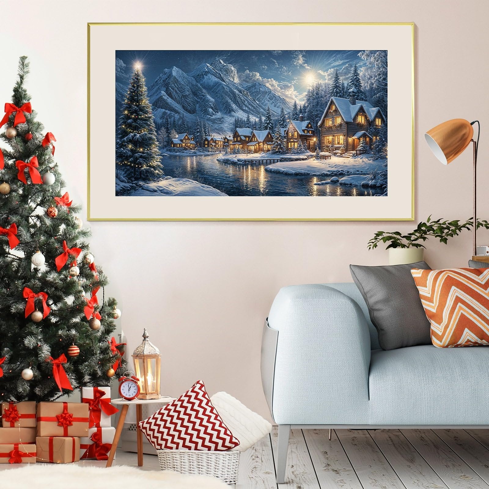 Christmas village scene painting hanging on wall next to decorated Christmas tree and sofa