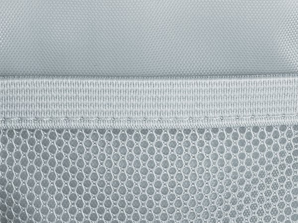 Close-up of gray fabric with mesh pocket and elastic band detail on a pencil case.