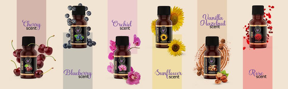 Collection of five fragrance oil bottles with cherry, blueberry, orchid, sunflower, vanilla hazelnut, and rose scents, each with corresponding fruit or flower imagery.