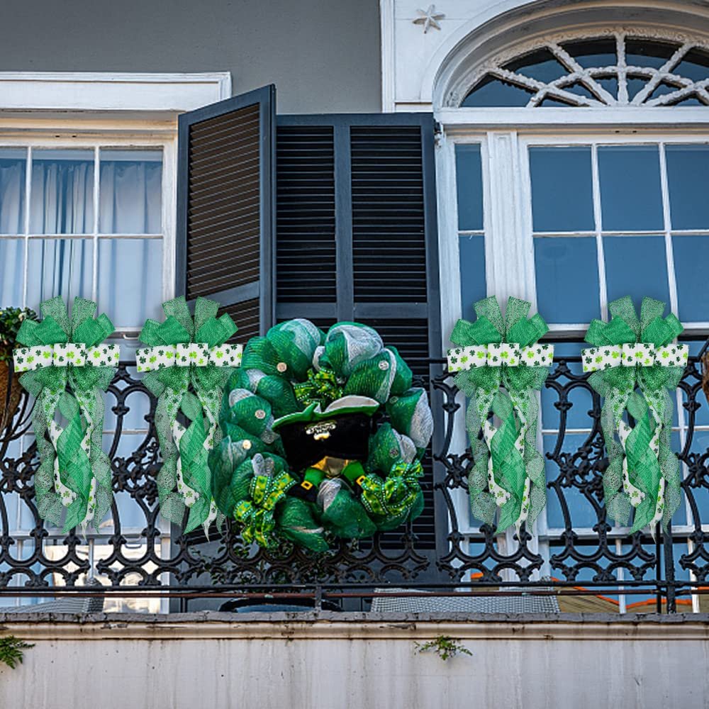 St. Patrick's Day wreath and bows decorated with green glitter and shamrocks, displayed on a balcony railing.
