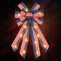 Patriotic burlap bow with warm white LED lights, featuring red, white, and blue stars and stripes pattern.