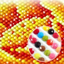 Close-up of a diamond painting kit with colorful round diamonds arranged in rows, inset shows a tray of individual diamonds.