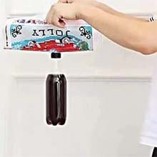 Hands holding a dispenser with a bottle of dark liquid hanging from it