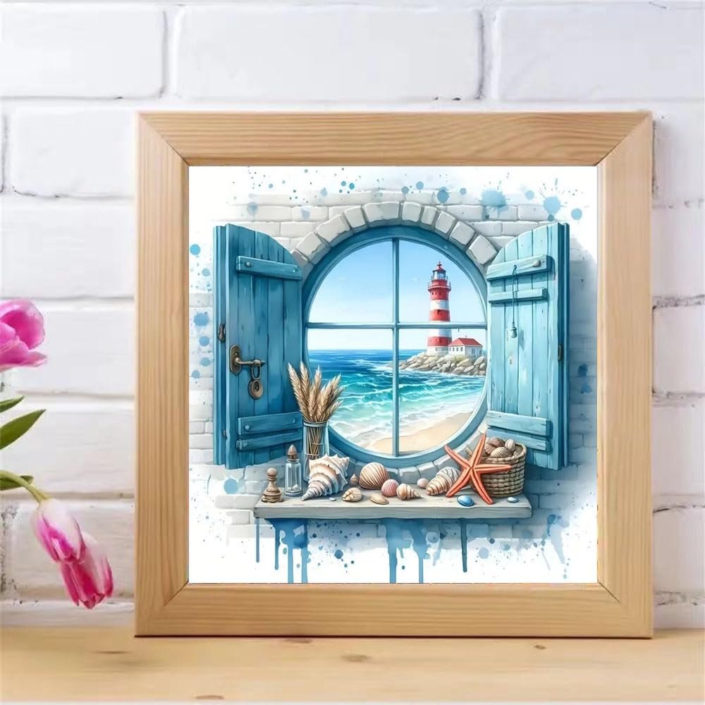 Diamond painting kit showing a lighthouse scene through a round window with blue shutters and seashells on the sill.