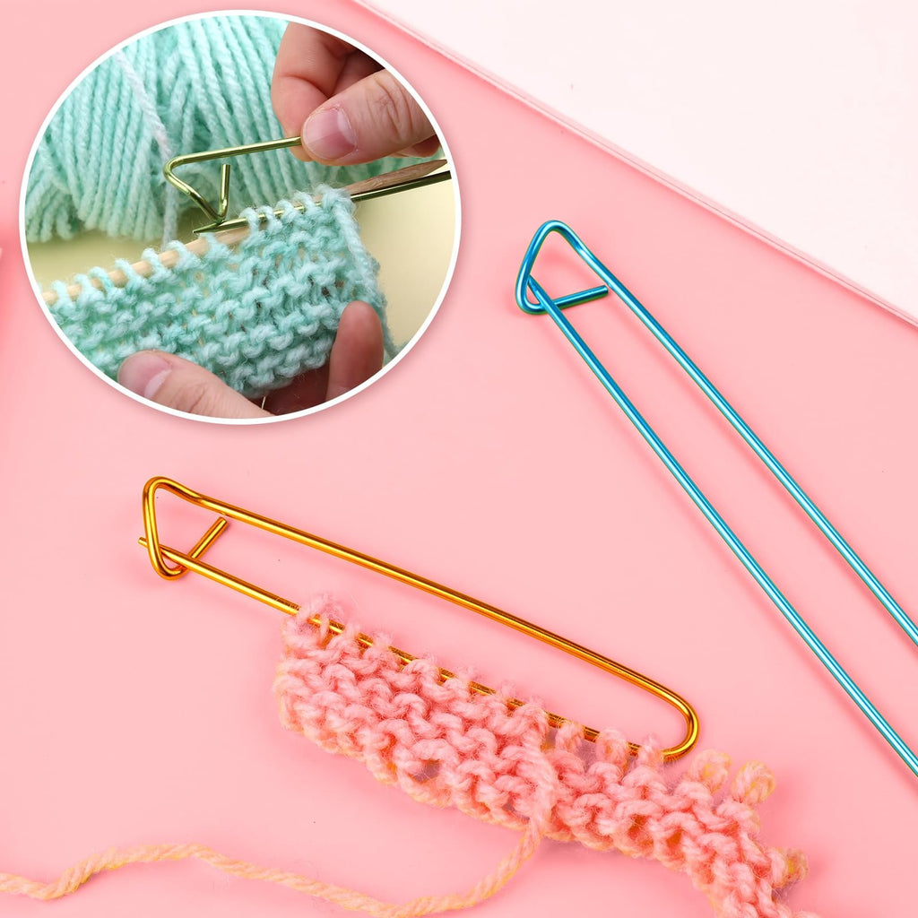Knitting needles and stitch holders with yarn and knitted swatches on a pink background