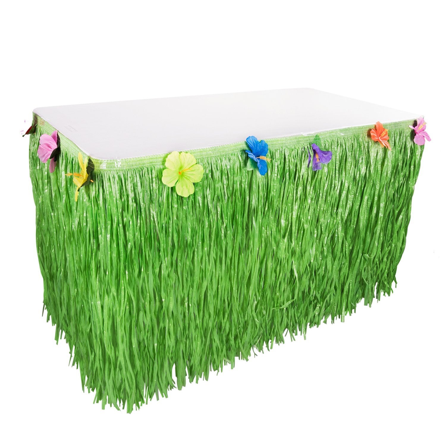 Green luau grass table skirt with colorful hibiscus flowers attached to the top edge, shown on a white table against a white background.