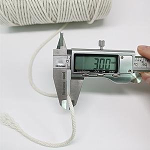 Close-up of white 3mm cotton cord being measured with a digital caliper showing 3.00mm on a white background.