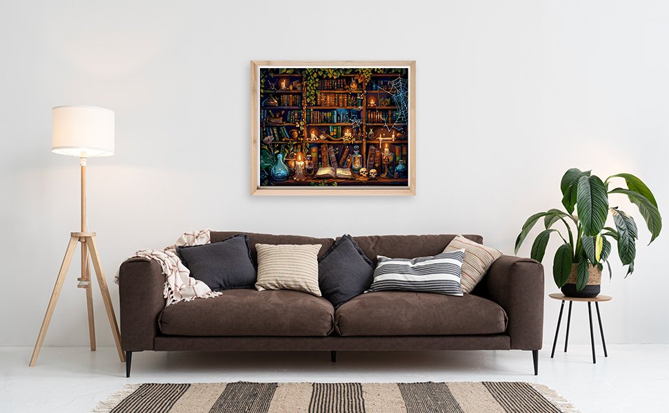 Framed paint by numbers artwork of a magical bookshelf with potions and candles, displayed above a sofa.