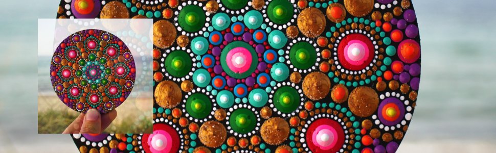 Close-up of a hand holding a painted mandala coaster with colorful dots on a beach background. The main image shows a larger mandala painting.