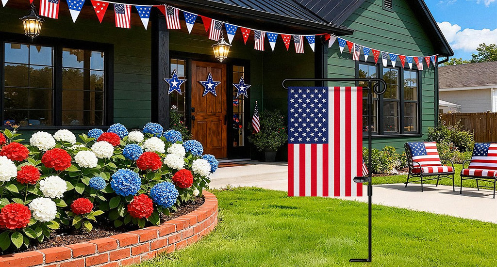 Metal garden flag stand with American flag and patriotic decorations on a house porch.