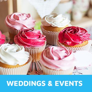Assortment of cupcakes with pink and white frosting in paper liners, with a small blank tag and a blue banner.
