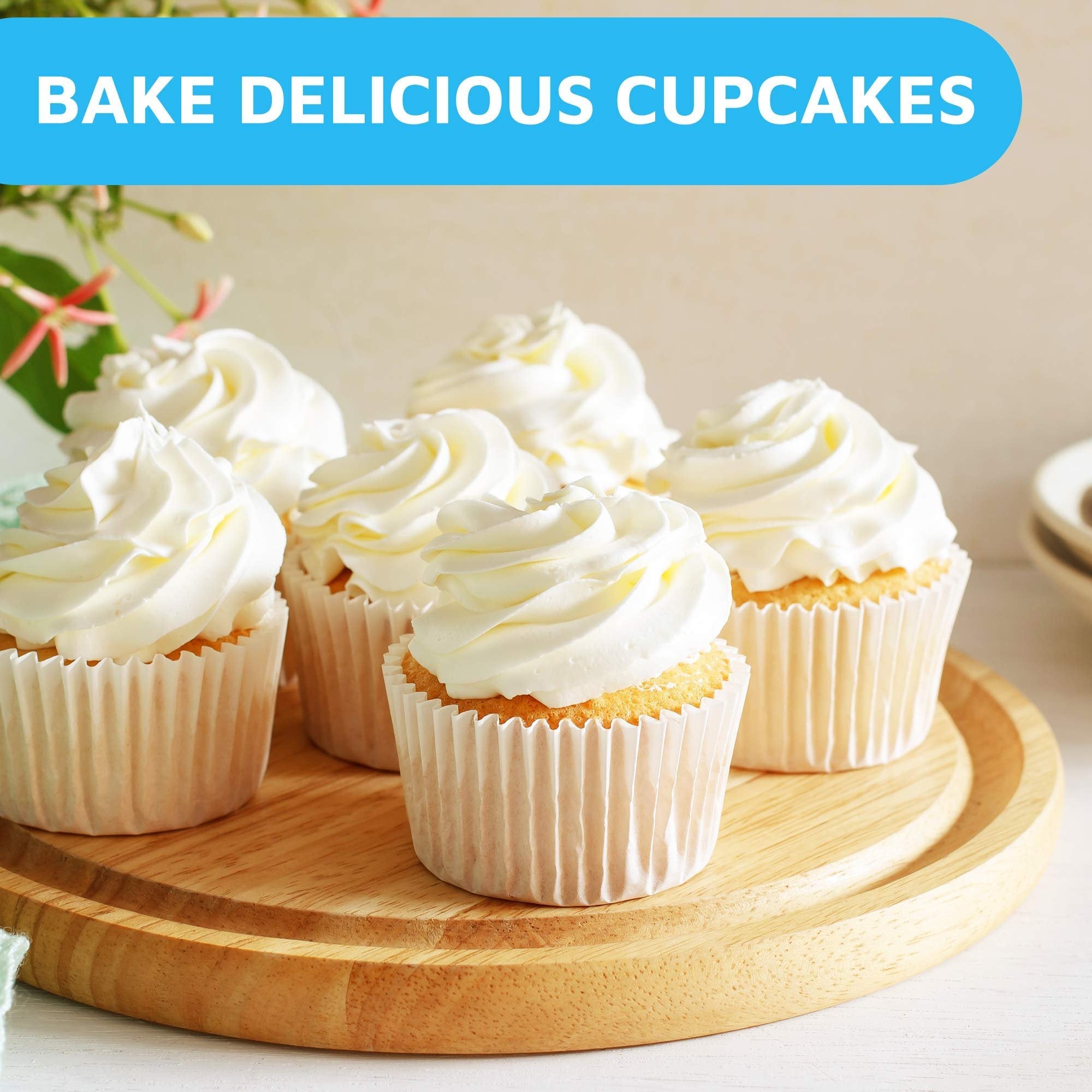 Six frosted cupcakes in white paper liners on a wooden board, with a blue banner reading 'BAKE DELICIOUS CUPCAKES' at the top.