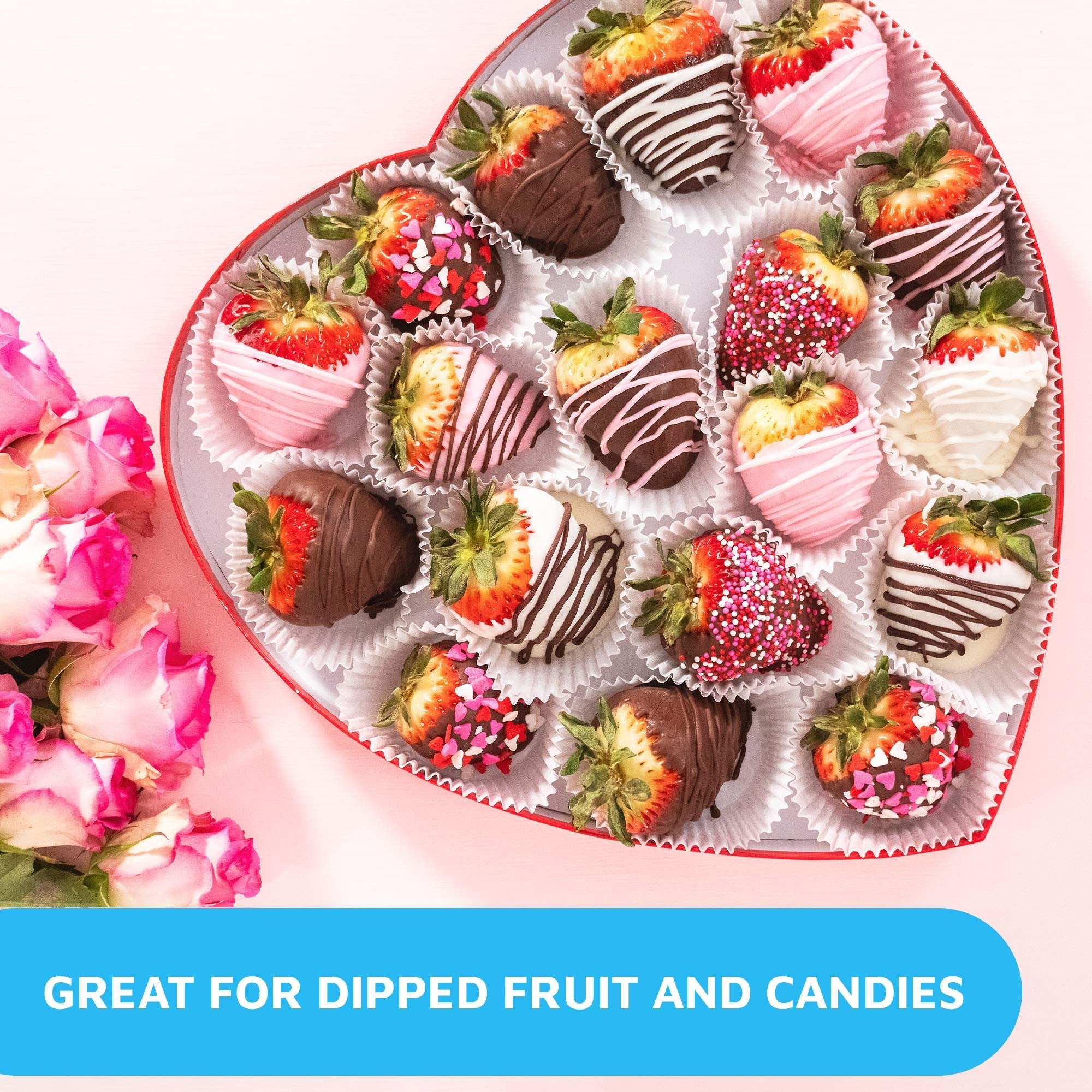 Heart-shaped box of chocolate-dipped strawberries with pink roses on the side