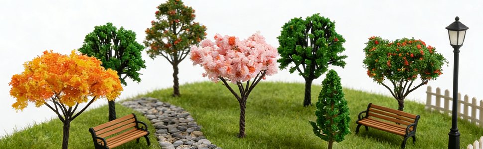 Miniature garden scene with assorted artificial trees, benches, a lamppost, and a stone path.