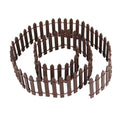 Brown miniature wood picket fence coiled on a white background, showing its detailed construction.
