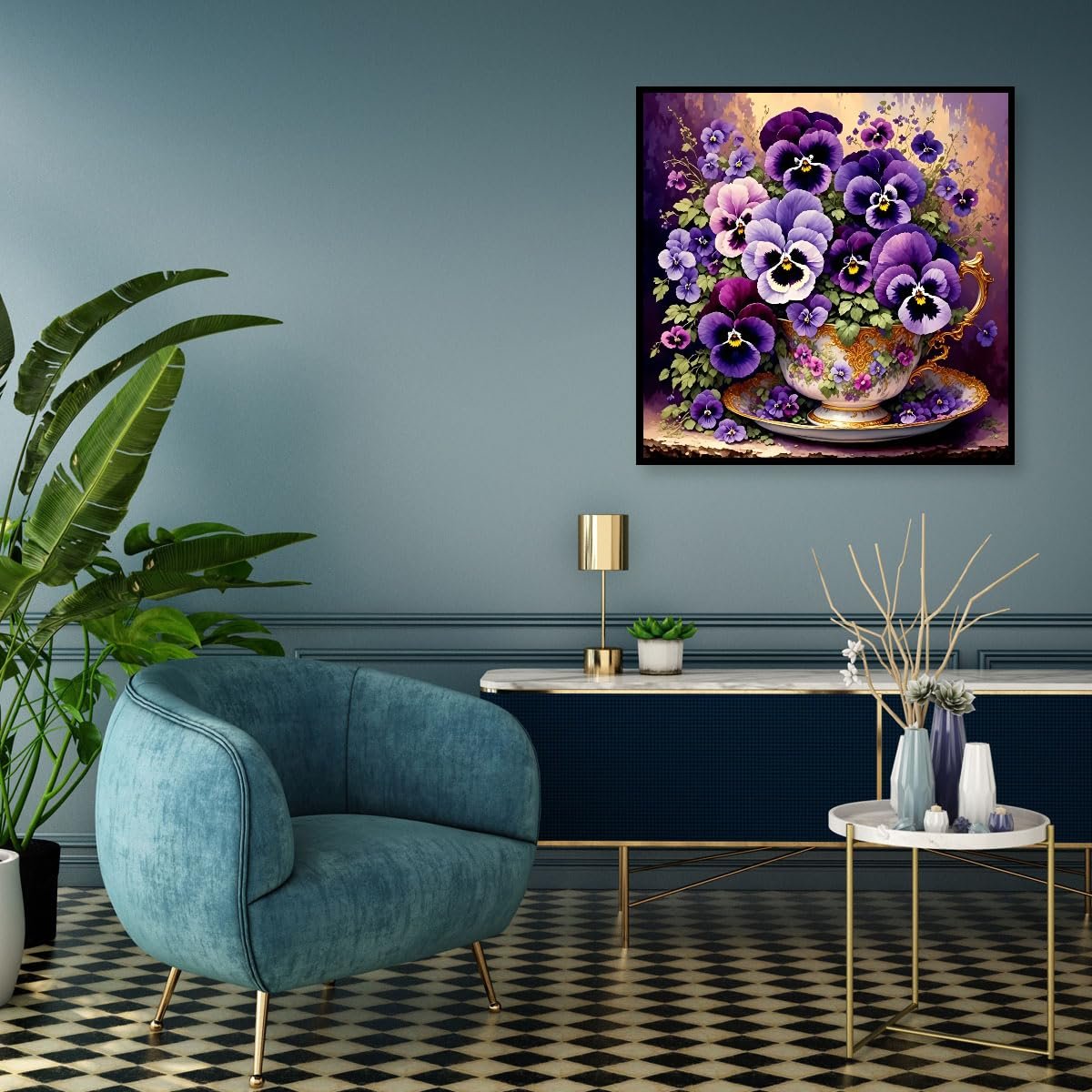 Diamond painting of purple pansies in a teacup displayed on a wall in a living room setting.