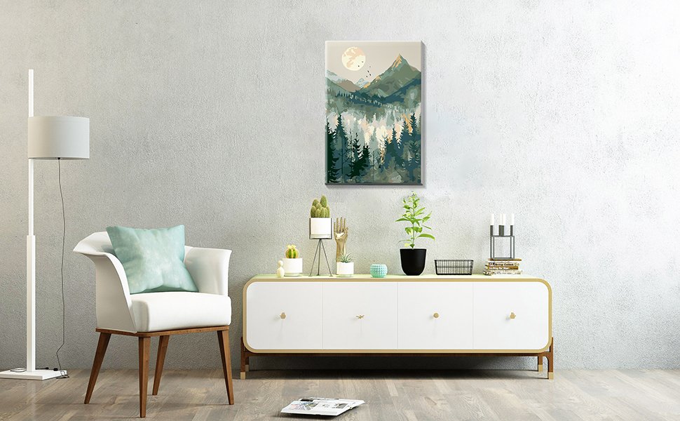 Framed mountain landscape painting displayed above a credenza with plants and decor