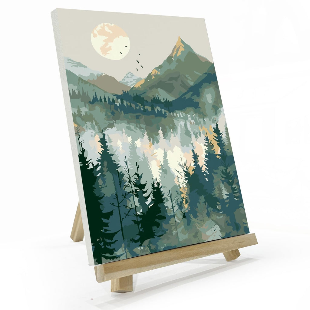Paint by number canvas showing a mountain landscape with a sun and pine trees, displayed on a wooden easel.