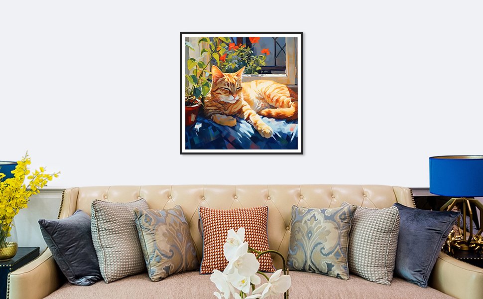 Framed diamond painting of an orange tabby cat lounging on a blue blanket by a window with plants.