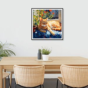 Framed diamond painting of a napping cat on a blue blanket, displayed on a wall above a dining table.