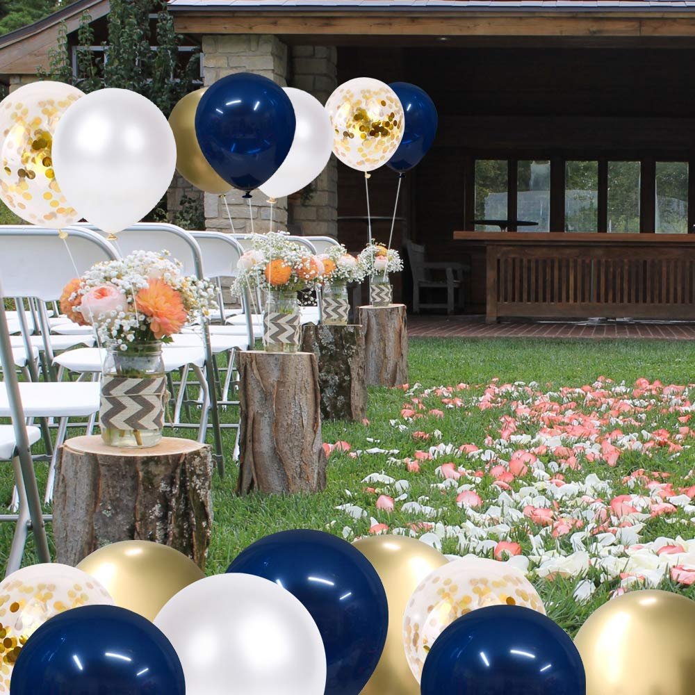 Navy blue, pearl white, and gold confetti balloons arranged for an outdoor event with chairs and floral decorations.