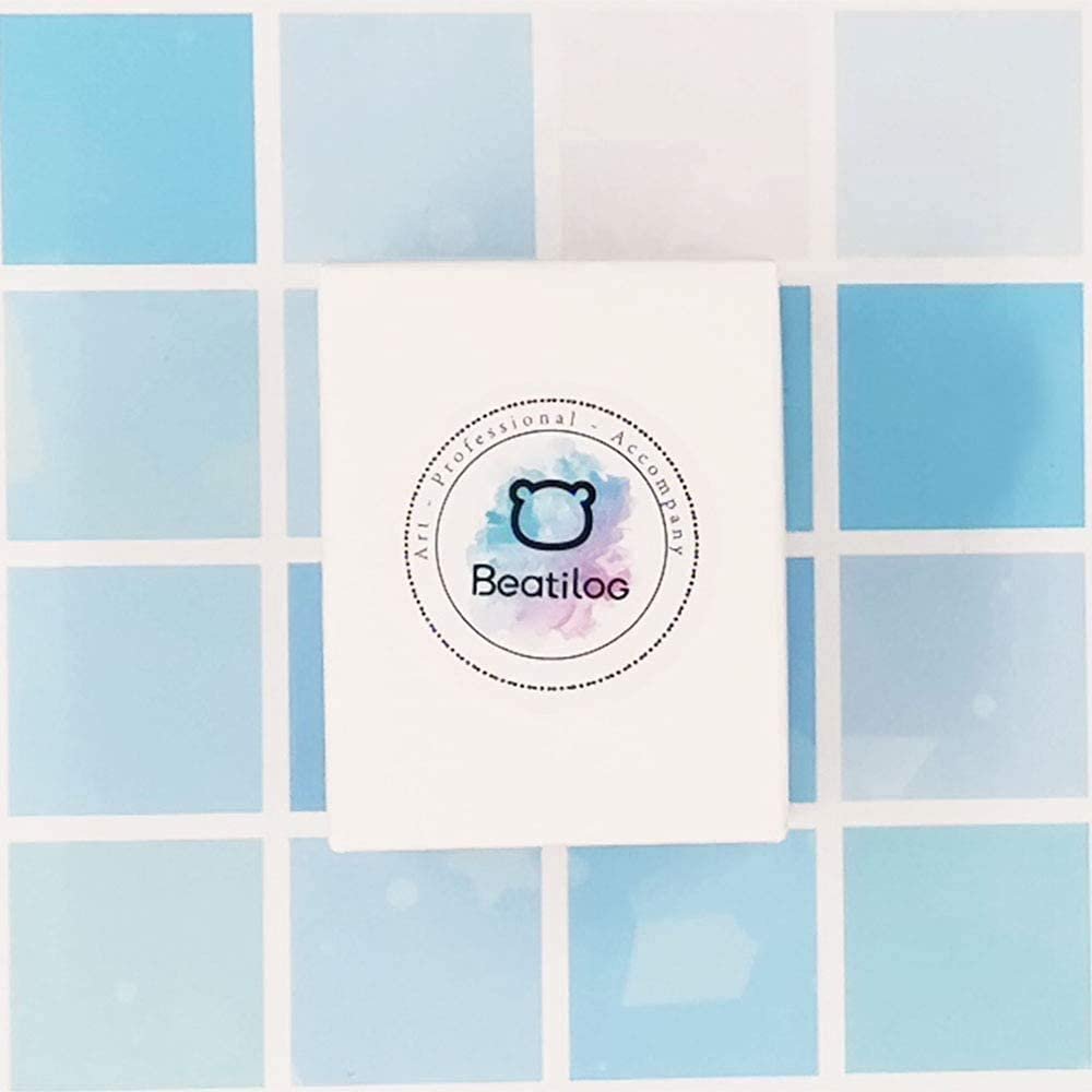 White ring box with logo on a light blue tiled background