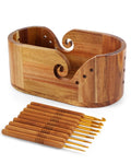 Oval wooden yarn bowl with a set of 9 crochet hooks, shown from a slightly elevated angle on a white background.